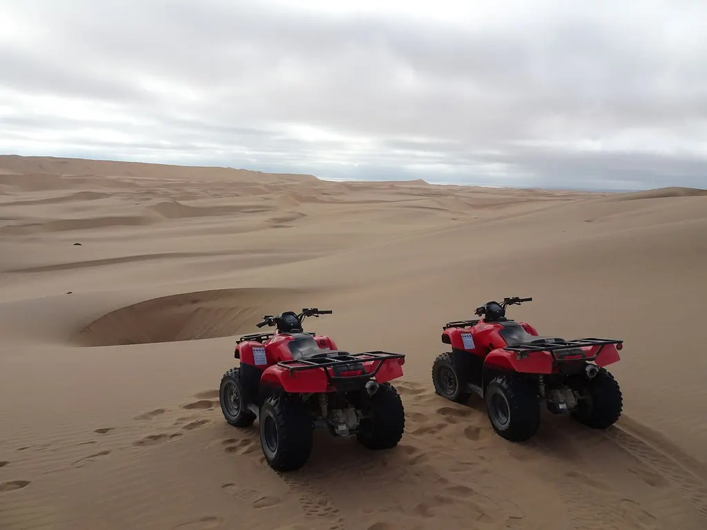Guided quad-bike activity on desert dunes