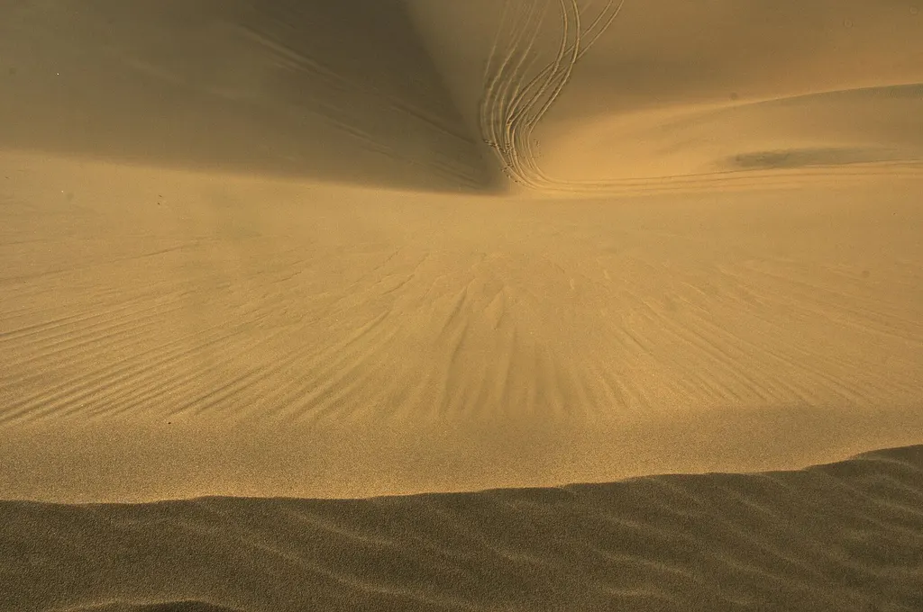 Sand dunes meeting the Atlantic near Sandwich Harbour, Namibia