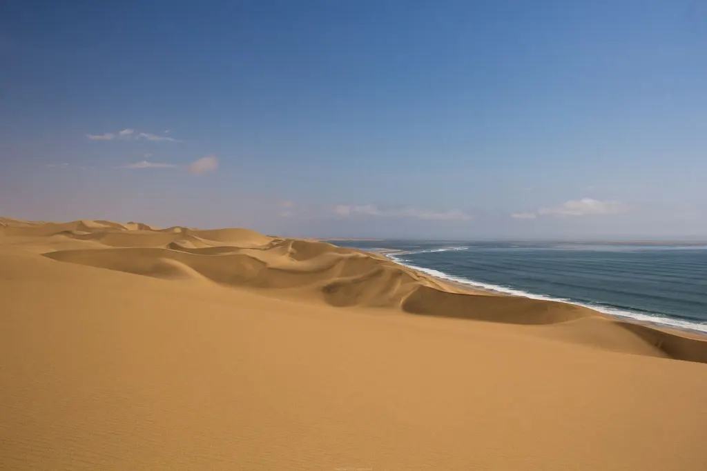 Sand dunes meeting the Atlantic near Sandwich Harbour, Namibia