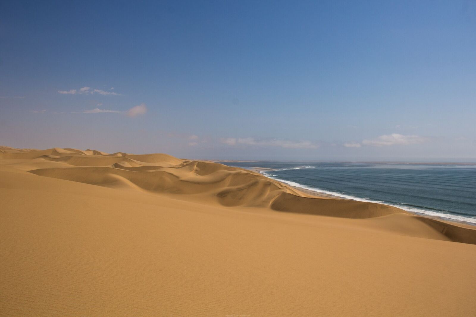 Sand dunes meeting the Atlantic near Sandwich Harbour, Namibia