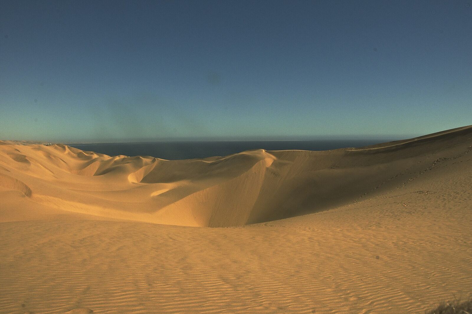 Sand dunes meeting the Atlantic near Sandwich Harbour, Namibia