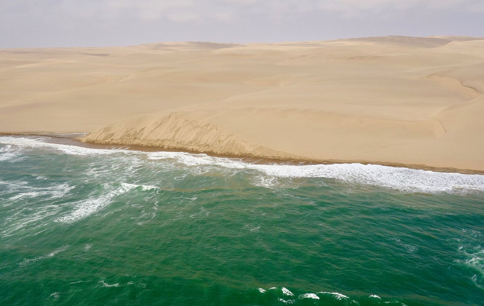 Aerial view where the Namib Desert meets the Atlantic Ocean