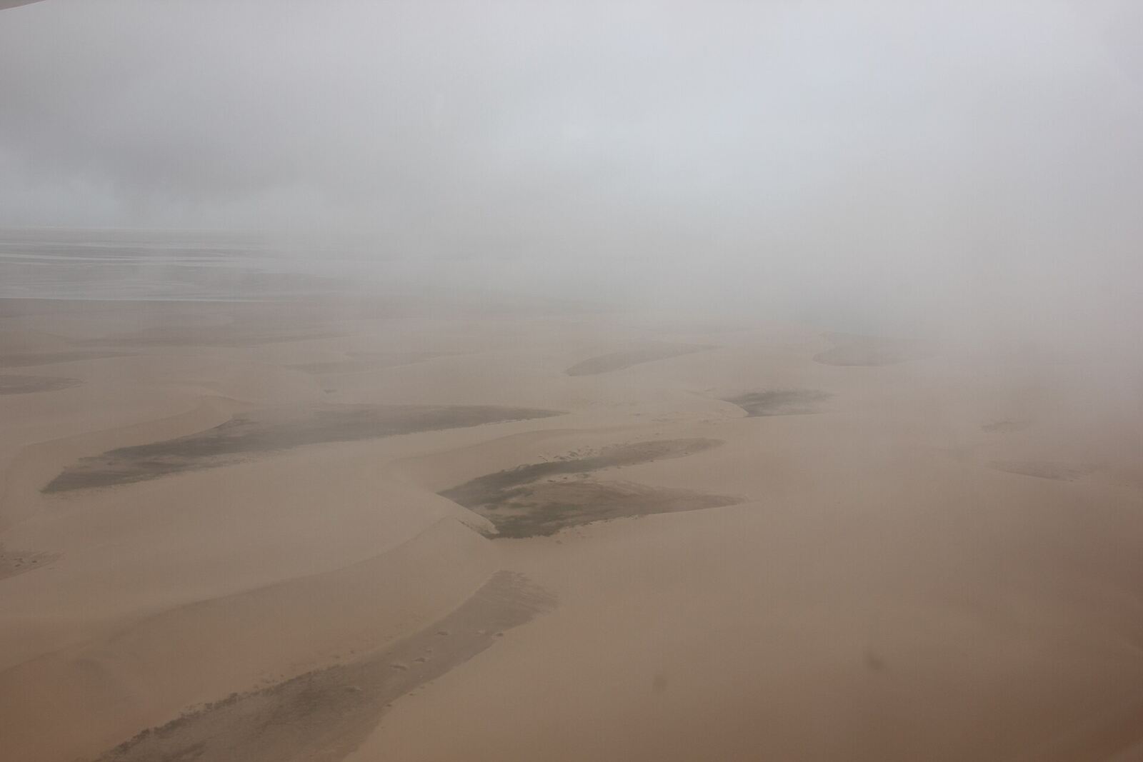 Fog drifting over the dunes of Namibia's Skeleton Coast
